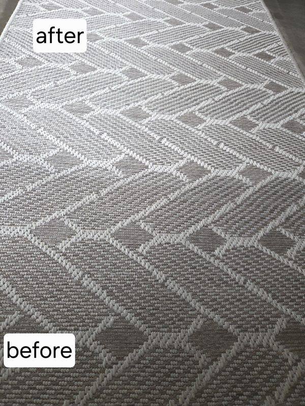 Patterned gray carpet showing the cleaned section above and soiled section below